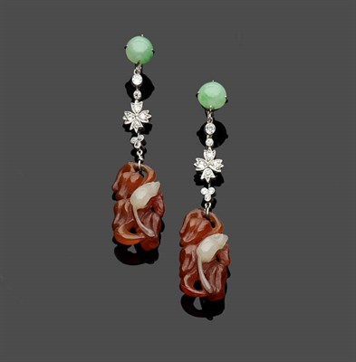 Lot 473 - A Pair of Drop Earrings, a jade cabochon bead suspends a diamond set panel, and a carved...