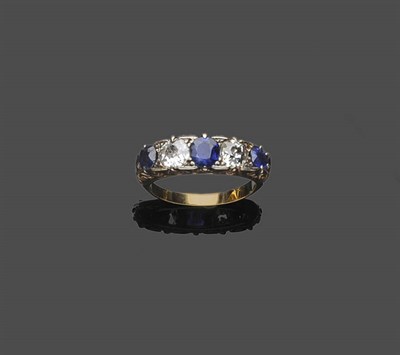 Lot 486 - A Sapphire and Diamond Five Stone Ring, the oval mixed cut sapphires alternated with old cut...