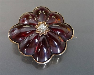 Lot 488 - A Victorian Diamond and Garnet Memorial Brooch, an old mine cut diamond centres the scalloped...