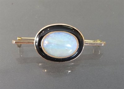 Lot 489 - An Opal and Black Enamel Bar Brooch, the oval cabochon opal sits within a broad black enamel frame