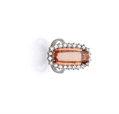 Lot 501 - An 14 Carat White Gold Topaz and Diamond Cluster Ring, the oval step cut orange coloured topaz...