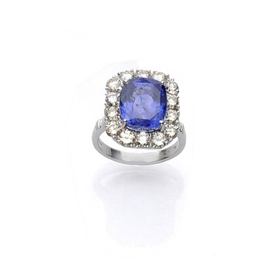 Lot 502 - An 18 Carat White Gold Sapphire and Diamond Cluster Ring, a cushion cut sapphire within a border of