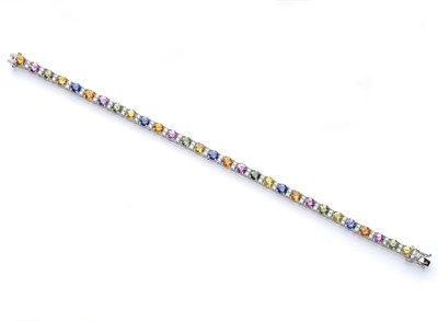 Lot 506 - A Multi Coloured Sapphire and Diamond Line Bracelet, the alternating series of yellow, green, pink