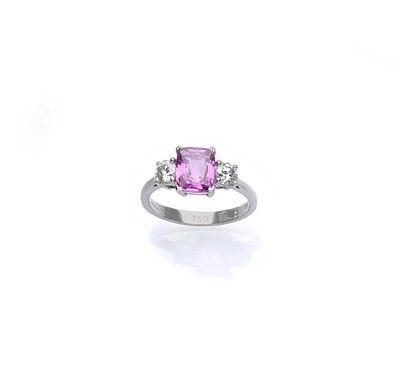 Lot 508 - An 18 Carat White Gold Pink Sapphire and Diamond Ring, the cushion cut pink sapphire flanked by...