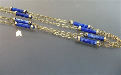 Lot 517 - An 18 Carat Gold Lapis Lazuli Necklace, faceted columns of lapis lazuli are spaced by sections...