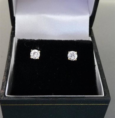 Lot 519 - A Pair of Diamond Solitaire Stud Earrings, the round brilliant cut diamonds held in four claw...