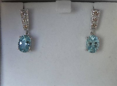 Lot 521 - A Pair of Aquamarine and Diamond Earrings, graduated round brilliant cut diamonds in a tapered...