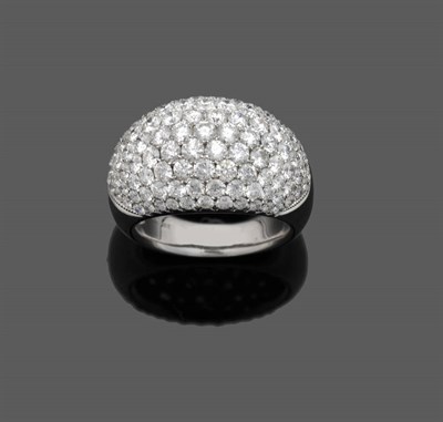 Lot 530 - A Diamond Bombé Ring, the varying sizes of round brilliant cut diamonds mounted in a clustered...