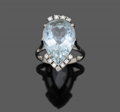 Lot 533 - An Aquamarine and Diamond Cluster Ring, the pear cut aquamarine with four round brilliant cut...