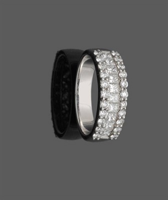 Lot 535 - A Three Row Diamond Half Eternity Ring, a row of princess cut diamonds sits between two rows of...