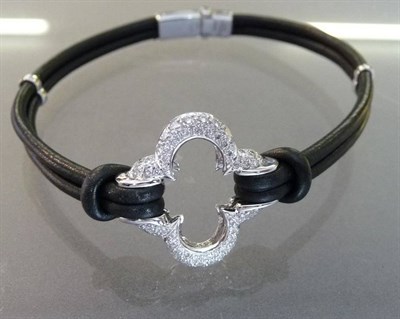 Lot 546 - An 18 Carat White Gold Diamond Set Clover Bracelet, by Mouawad and Heidi Klum, round brilliant...