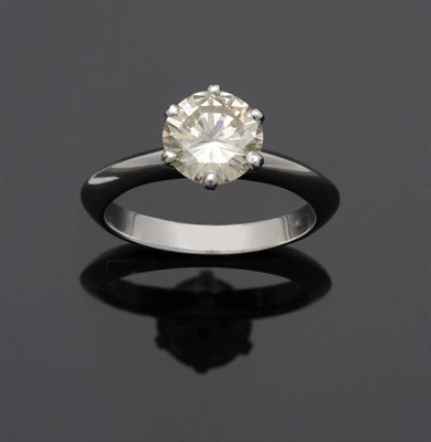 Lot 551 - A Diamond Solitaire Ring, the round brilliant cut diamond in a white six claw setting to a...