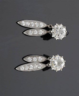 Lot 553 - A Pair of Diamond Drop Earrings, each comprising a round brilliant cut diamond solitaire stud...