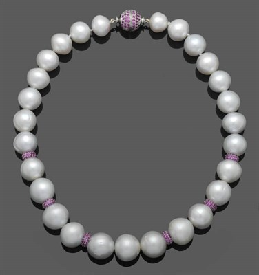 Lot 555 - A Cultured South Sea Pearl Necklace, the slightly graduated pearls interspersed by pink...