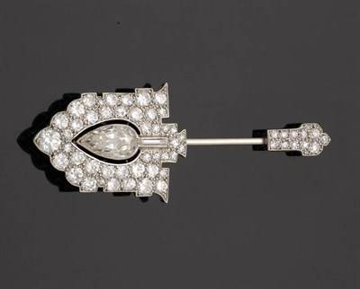 Lot 556 - A Diamond Jabot Pin, by Cartier, the arrow head formed of a pear cut diamond in a pierced...