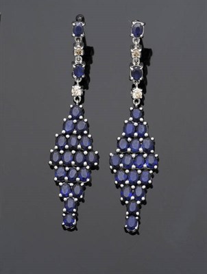 Lot 557 - A Pair of Sapphire and Diamond Drop Earrings, chain linked oval cut sapphires and round...