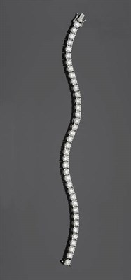 Lot 559 - An 18 Carat White Gold Diamond Line Bracelet, thirty-eight round brilliant cut diamonds in claw...