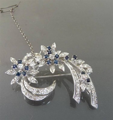 Lot 564 - An 18 Carat White Gold Sapphire and Diamond Floral Spray Brooch, the round brilliant cut stones...