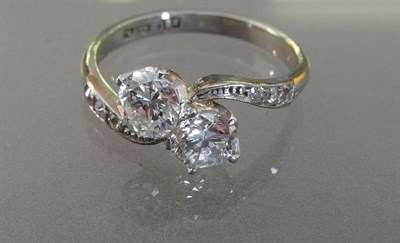 Lot 566 - A Diamond Two Stone Twist Ring, the round brilliant cut diamonds in white claw settings within...