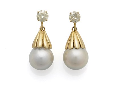 Lot 575 - A Pair of Diamond and Cultured Pearl Earrings, the round brilliant cut diamonds suspend grooved...