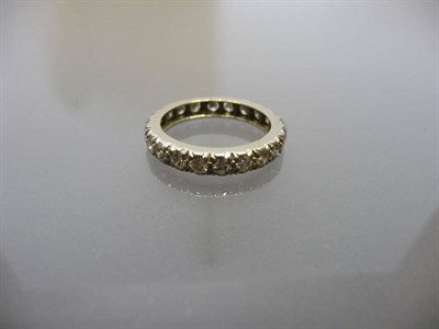 Lot 578 - A Diamond Eternity Ring, round brilliant cut diamonds held in white claw carved settings on a plain