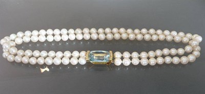 Lot 579 - A Cultured Pearl Necklace with an Aquamarine and Diamond Clasp, the double row of cultured...