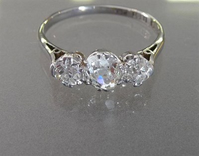 Lot 580 - A Diamond Three Stone Ring, circa 1910, the graduated old cut diamonds held in white claw...