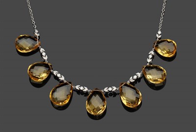 Lot 585 - A Citrine and Diamond Drop Necklace, the seven briolette citrines spaced by diamond set panels on a