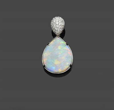 Lot 587 - An Opal and Diamond Pendant, the pear shaped flat polished black opal in a white claw and...