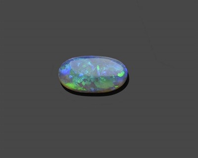 Lot 597 - A Loose Oval Cabochon Opal, weighing approximately 6.50 carat, a dark grey background with...