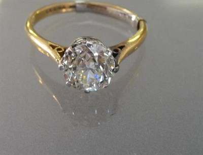 Lot 604 - A Diamond Solitaire Ring, the old cut diamond held in a white six claw setting to a yellow...