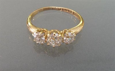 Lot 606 - An 18 Carat Gold Diamond Three Stone Ring, the graduated old cut diamonds in yellow claw...