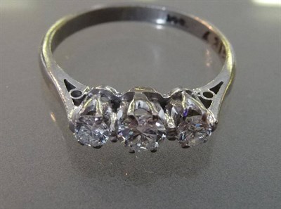 Lot 607 - A Diamond Three Stone Ring, the graduated round brilliant cut diamonds in white claw settings...