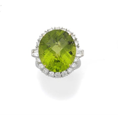 Lot 616 - An 18 Carat White Gold Peridot and Diamond Ring, the rose cut peridot within a border of round...