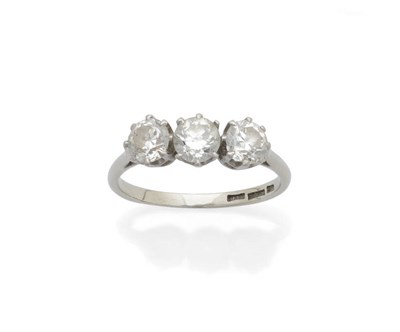 Lot 619 - A Diamond Three Stone Ring, the round brilliant cut diamonds held in white claw settings to a plain