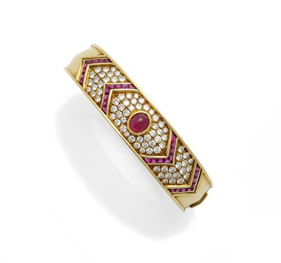 Lot 626 - A Fine Quality 18 Carat Gold Ruby and Diamond Cluster Bangle, a central cabochon ruby sits...