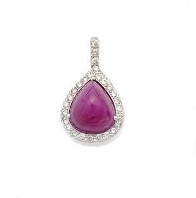 Lot 632 - An 18 Carat White Gold Ruby and Diamond Pendant, the domed triangular cabochon ruby within a border