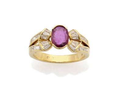 Lot 635 - A Ruby and Diamond Fancy Ring, an oval cut ruby is flanked by baguette cut diamonds in a fancy...