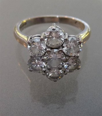 Lot 636 - An 18 Carat Gold Diamond Cluster Ring, seven round brilliant cut diamonds in white claw...