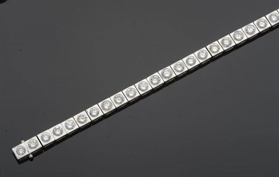 Lot 649 - An 18 Carat White Gold Line Bracelet, thirty-three round brilliant cut diamonds in white square...