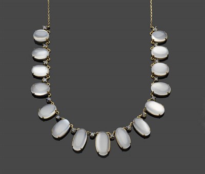 Lot 653 - A Moonstone and Sapphire Fringe Necklace, graduated oval cabochon moonstones are spaced by...