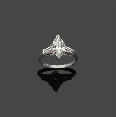 Lot 659 - A Marquise Cut Diamond Ring, the central marquise cut diamond flanked by a tapered baguette cut...