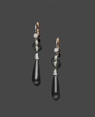 Lot 661 - A Pair of Onyx and Diamond Drop Earrings, a round brilliant cut diamond suspends an onyx hoop...