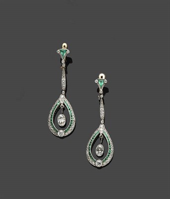 Lot 662 - A Pair of Emerald and Diamond Drop Earrings, an oval cut diamond is suspended within a two row...