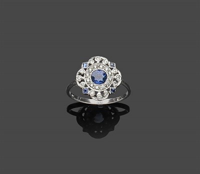 Lot 665 - A Sapphire and Diamond Cluster Ring, the central oval cut sapphire within a pierced frame set...