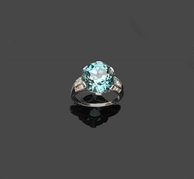 Lot 667 - A Blue Zircon and Diamond Ring, the round brilliant cut blue zircon in a white claw setting...