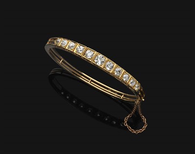 Lot 671 - A Victorian Diamond Bangle, the graduated old cut diamonds in yellow claw settings on a carved...