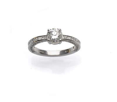 Lot 682 - An 18 Carat White Gold Diamond Ring, the central round brilliant cut diamond in a four claw setting