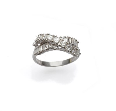 Lot 683 - A Diamond Dress Ring, a curved line of round brilliant cut diamonds crosses one of baguette cut...