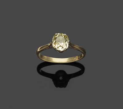 Lot 698 - A Diamond Solitaire Ring, the old cut diamond in a white six claw setting on a yellow plain...